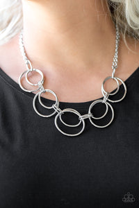 Doubled silver hoops link below the collar for a bold industrial look. Features an adjustable clasp closure.  Sold as one individual necklace. Includes one pair of matching earrings.  Always nickel and lead free.