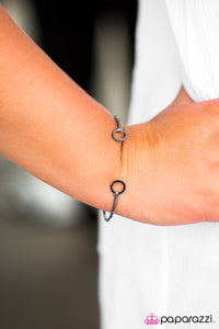 Featuring rounded fittings, a glistening gunmetal bar curls around the wrist, creating a dainty cuff.  Sold as one individual bracelet.  Always nickel and lead free.