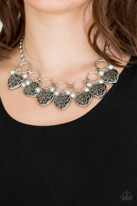 Infused with classic silver pearls, vintage locket-like heart frames swing from the bottoms of bold silver hoops, creating a flirtatious fringe below the collar. Features an adjustable clasp closure.  Sold as one individual necklace. Includes one pair of matching earrings.   Always nickel and lead free.
