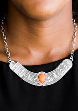 Load image into Gallery viewer, Embossed in floral and tribal inspired patterns, a shimmery silver crescent shaped frame swings below the collar in a fierce fashion. Chiseled into a tranquil teardrop, a vivacious orange stone is pressed into the center of the dramatic pendant for a seasonal finish. Features an adjustable clasp closure.  Sold as one individual necklace. Includes one pair of matching earrings.  Always nickel and lead free.