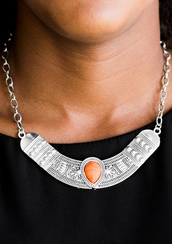 Embossed in floral and tribal inspired patterns, a shimmery silver crescent shaped frame swings below the collar in a fierce fashion. Chiseled into a tranquil teardrop, a vivacious orange stone is pressed into the center of the dramatic pendant for a seasonal finish. Features an adjustable clasp closure.  Sold as one individual necklace. Includes one pair of matching earrings.  Always nickel and lead free.