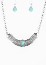 Load image into Gallery viewer, Embossed in floral and tribal inspired patterns, a shimmery silver crescent shaped frame swings below the collar in a fierce fashion. Chiseled into a tranquil teardrop, a refreshing turquoise stone is pressed into the center of the dramatic pendant for a seasonal finish. Features an adjustable clasp closure.  Sold as one individual necklace. Includes one pair of matching earrings.