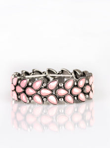 Faceted pink teardrop beads and shimmery silver studs coalesce into ornate frames. The whimsical frames are threaded along stretchy bands around the wrist for a seasonal look.  Sold as one individual bracelet.