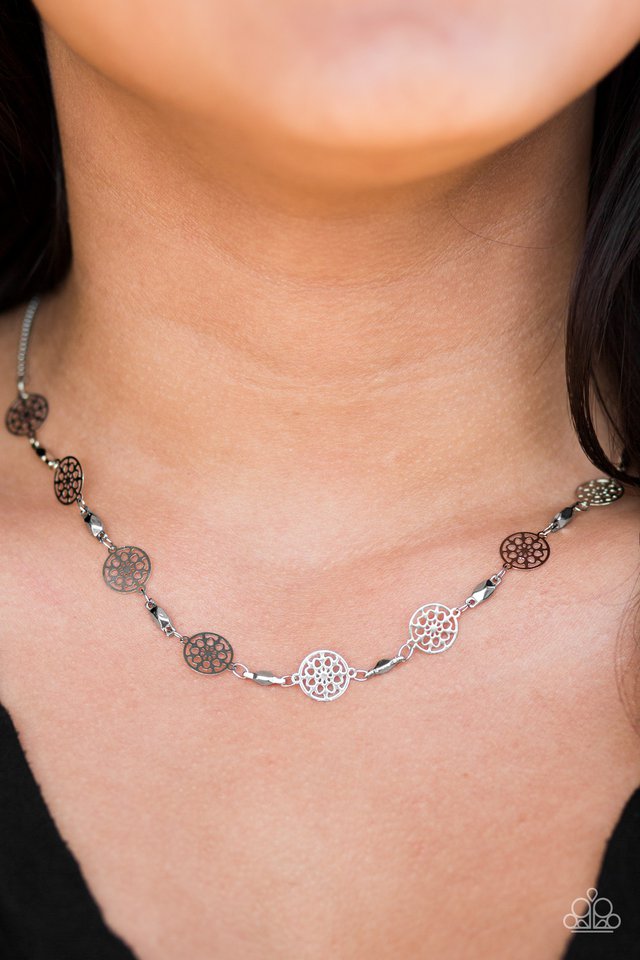 Featuring feminine floral centers, dainty wheel-like discs link below the collar in a whimsical fashion. Features an adjustable clasp closure.  Sold as one individual necklace. Includes one pair of matching earrings.  Always nickel and lead free.