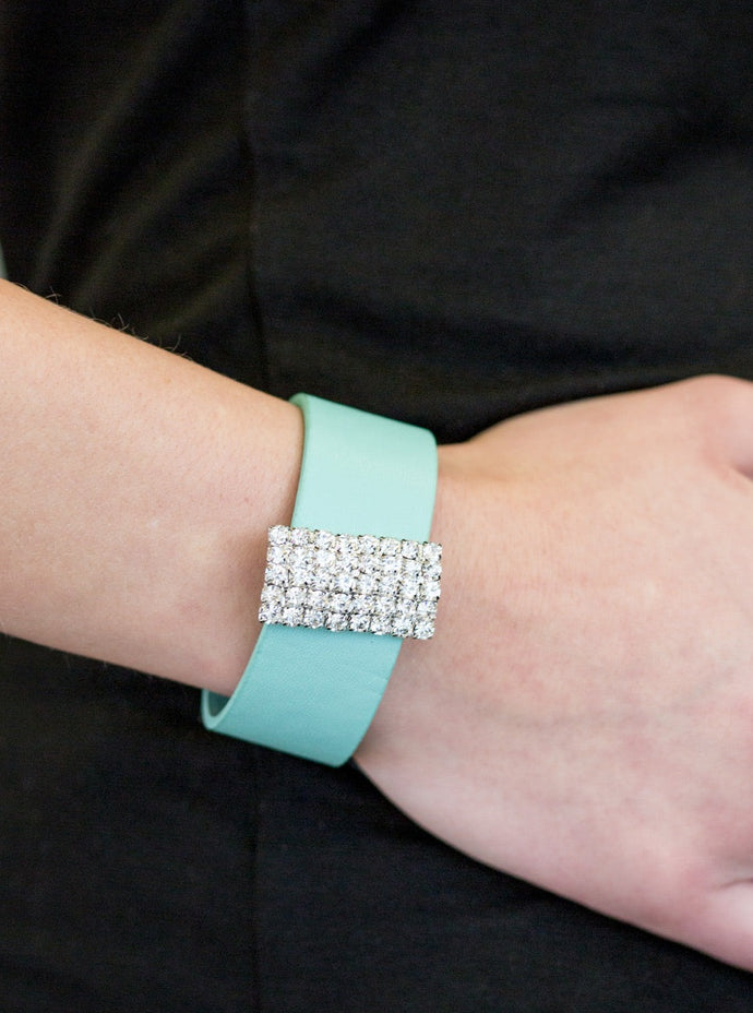 Encrusted in glittery white rhinestones, a sparkling frame slides along a strip of green leather, creating a blinding centerpiece. Features an adjustable snap closure.  Sold as one individual bracelet.