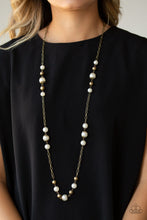 Load image into Gallery viewer,   Capped in ornate brass frames, a collection of bubbly white pearls and glistening brass beads trickle along sections of shiny brass chain across the chest for a timeless sophistication. Features an adjustable clasp closure.  Sold as one individual necklace. Includes one pair of matching earrings. Always nickel and lead free.