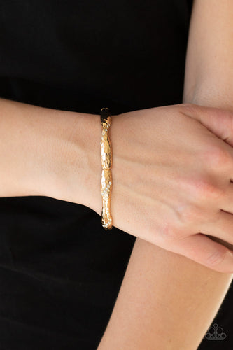 Encrusted in ribbons of glassy white rhinestones, hammered gold frames are threaded along a stretchy band around the wrist for a refined look.  Sold as one individual bracelet.  Always nickel and lead free.