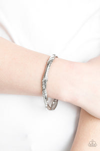 Encrusted in ribbons of glassy white rhinestones, hammered silver frames are threaded along a stretchy band around the wrist for a refined look.  Sold as one individual bracelet.  Always nickel and lead free.