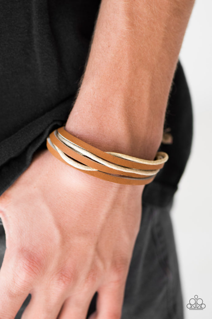 Strands of leather and twine layer across the wrist for an earthy urban look. Features an adjustable sliding knot closure.  Sold as one individual bracelet.  Always nickel and lead free.