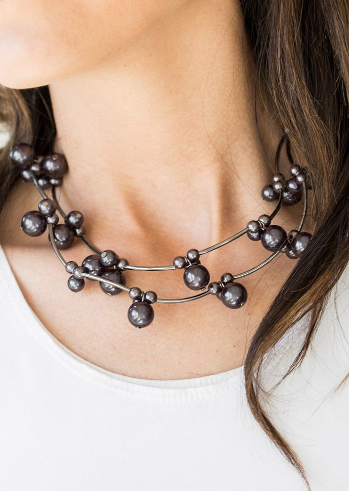 Cylindrical gunmetal beads and clusters of pearly gunmetal beads are threaded along invisible wires, creating bubbly layers below the collar for a refined look. Features an adjustable clasp closure.  Sold as one individual necklace. Includes one pair of matching earrings. 