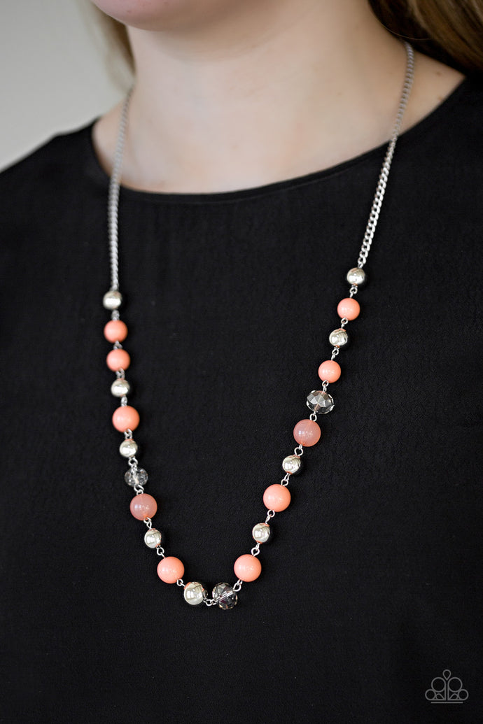 Classic silver beads and glittery crystal-like beads trickle along the bottom of a shimmery silver chain. Varying in opacity, refreshing coral beads are sprinkled between the refined accents for a seasonal finish. Features an adjustable clasp closure.  Sold as one individual necklace. Includes one pair of matching earrings.  Always nickel and lead free.