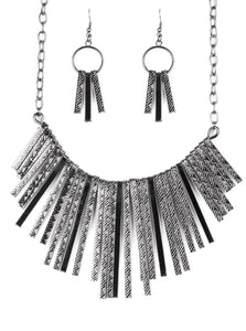 Embossed in edgy linear patterns, flat gunmetal rods alternate with plain gunmetal rods below the collar, creating a fiercely tapered fringe. Features an adjustable clasp closure.  Sold as one individual necklace. Includes one pair of matching earrings.