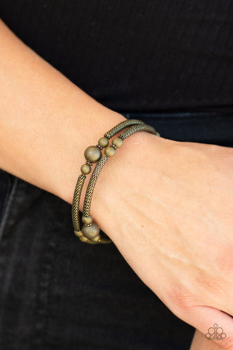 Sections of rounded brass wire mesh and antiqued brass beads are threaded along a coiled wire, creating a rustic infinity wrap style bracelet around the wrist.  Sold as one individual bracelet.  Always nickel and lead free.