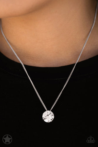 A single rhinestone sparkles brilliantly at the bottom of a dainty silver chain, creating a stunning solitaire design. Features an adjustable clasp closure.  Sold as one individual necklace. Includes one pair of matching earrings.  Always nickel and lead free.