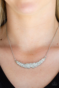 Encrusted in glassy white rhinestones, studded silver bars braid into a bowing pendant below the collar for a refined fashion. Features an adjustable clasp closure.  Sold as one individual necklace. Includes one pair of matching earrings.  Always nickel and lead free.