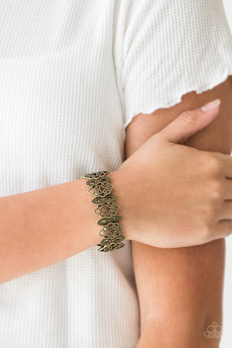 Radiating with studded detail, ornate brass filigree frames are threaded along stretchy bands around the wrist for a whimsical look.  Sold as one individual bracelet.   Always nickel and lead free.