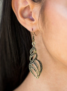Dotted in glistening studs, antiqued brass ribbons swirl and swoop into a flame-like lure. Earring attaches to a standard fishhook fitting.  Sold as one pair of earrings.