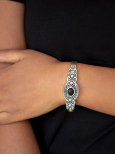 Dotted with an earthy black stone center, a dainty silver cuff radiating with shimmery southwestern inspired detail curls around the wrist for a seasonal look.  Sold as one individual bracelet.