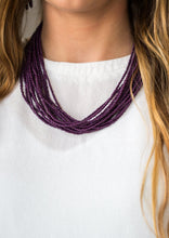 Load image into Gallery viewer, Infused with two large silver fittings, vivacious purple seed beads are threaded along countless strands, creating dramatic layers below the collar for a seasonal look. Features an adjustable clasp closure.  Sold as one individual necklace. Includes one pair of matching earrings.