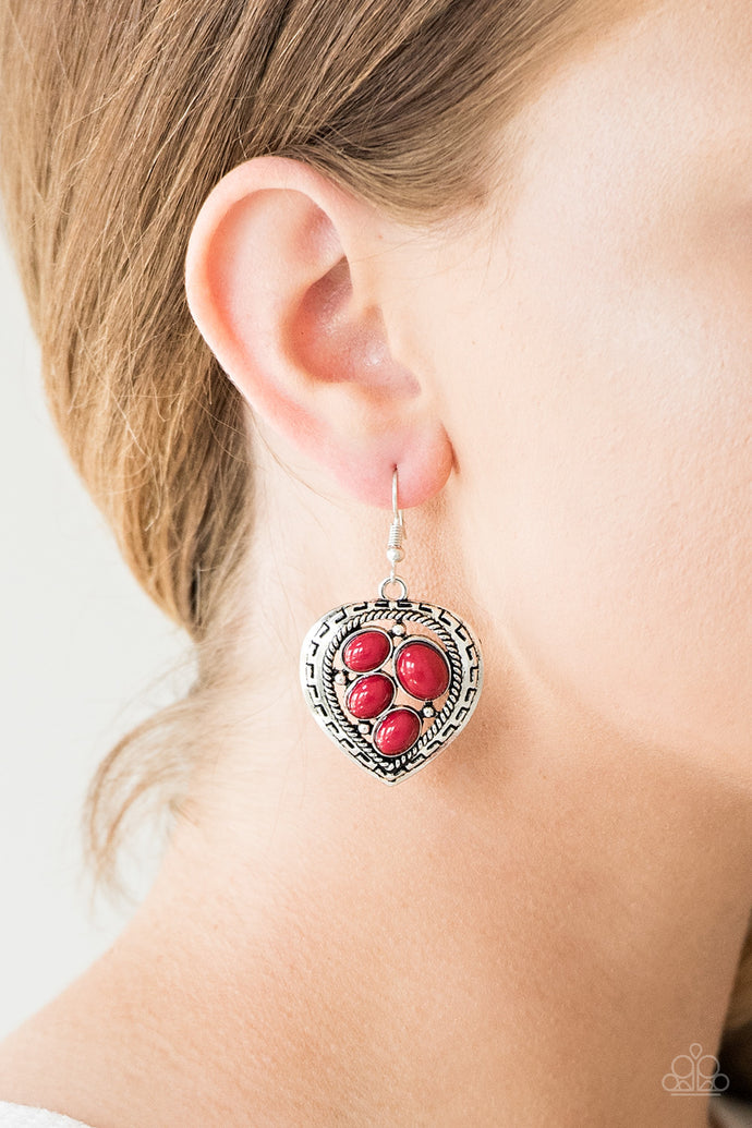 Varying in size, polished red beads are sprinkled across the center of an asymmetrical heart-shaped frame for a whimsical look. Earring attaches to a standard fishhook fitting.  Sold as one pair of earrings.  Always nickel and lead free.