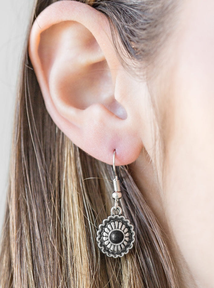 A dainty black bead is pressed into a shimmery silver frame radiating with floral details for a seasonal look. Earring attaches to a standard fishhook fitting.  Sold as one pair of earrings.