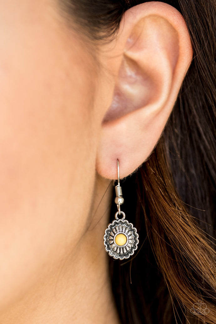 A dainty yellow bead is pressed into a shimmery silver frame radiating with floral details for a seasonal look. Earring attaches to a standard fishhook fitting.  Sold as one pair of earrings.  Always nickel and lead free.
