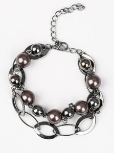 Necklace:  Two rows of classic gunmetal and pearly black beads, and glistening gunmetal hoops link below the collar in a refined fashion. Features an adjustable clasp closure.  Bracelet: Two rows of classic gunmetal and pearly black beads, and glistening gunmetal hoops link around the wrist in a refined fashion. Features an adjustable clasp closure.  Sold as one individual necklace, earrings, and bracelet.