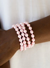 Load image into Gallery viewer, Rows of dainty and classic pink pearls are strung across the wrist for a timeless look. Features an adjustable clasp closure.  Sold as one individual bracelet.  