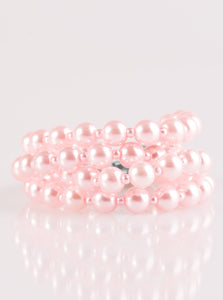 Rows of dainty and classic pink pearls are strung across the wrist for a timeless look. Features an adjustable clasp closure.  Sold as one individual bracelet.  