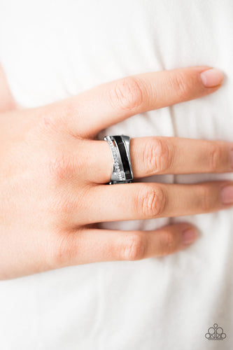 Encrusted in glittery white rhinestones and painted in black, a shimmery silver band wraps across the finger in a colorful fashion. Features a stretchy band for a flexible fit.  Sold as one individual ring.  Always nickel and lead free.
