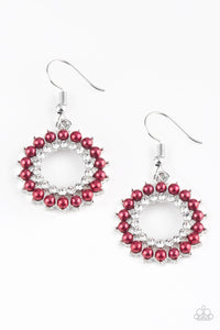 Dainty red pearls spin around a radiant white rhinestone center.