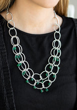 Load image into Gallery viewer, Green crystal-like beads swing from two layers of oversized silver links below the collar for a refined look. Features an adjustable clasp closure.  Sold as one individual necklace. Includes one pair of matching earrings.  
