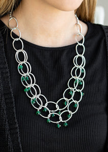 Green crystal-like beads swing from two layers of oversized silver links below the collar for a refined look. Features an adjustable clasp closure.  Sold as one individual necklace. Includes one pair of matching earrings.  