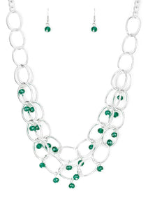 Green crystal-like beads swing from two layers of oversized silver links below the collar for a refined look. Features an adjustable clasp closure.  Sold as one individual necklace. Includes one pair of matching earrings.