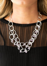 Load image into Gallery viewer, Pink crystal-like beads swing from two layers of oversized silver links below the collar for a refined look. Features an adjustable clasp closure.  Sold as one individual necklace. Includes one pair of matching earrings. 