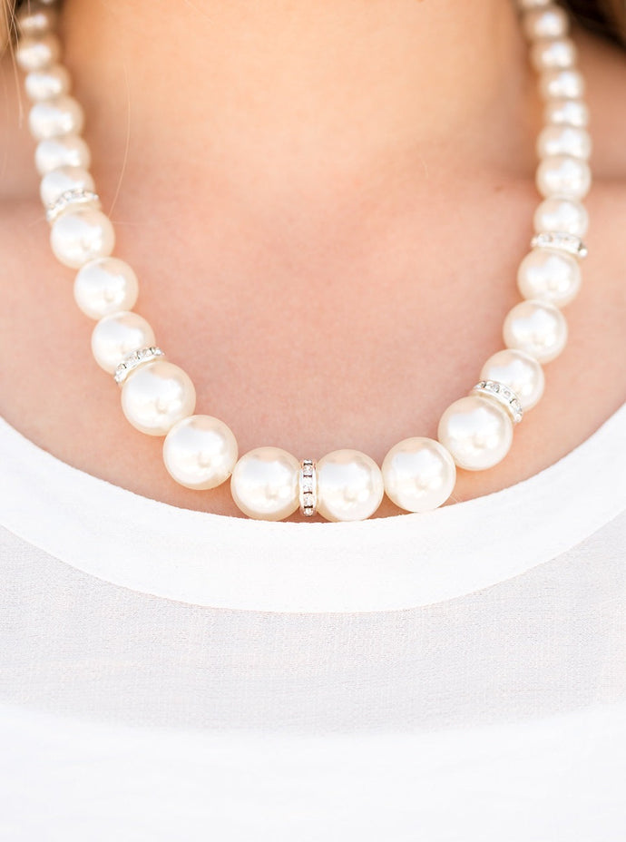 Gradually increasing in size, luminescent pearls trickle below the collar for a classic look. Encrusted in dazzling white rhinestones, glittery rings are sprinkled between the pearls for a timeless finish. Features an adjustable clasp closure.  Sold as one individual necklace. Includes one pair of matching earrings.