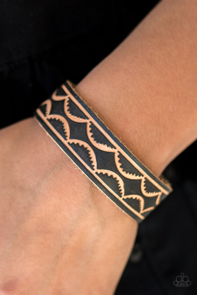 A strip of leather is stamped in a scalloped pattern for an earthy look. Features an adjustable snap closure.  Sold as one individual bracelet.  Always nickel and lead free.